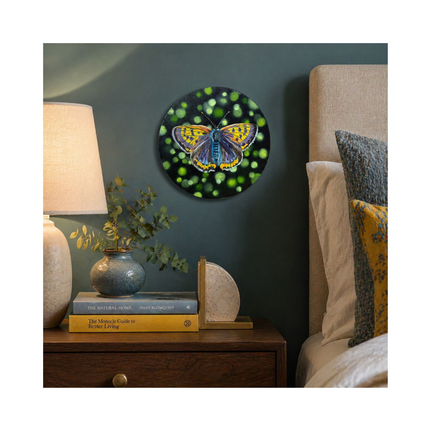 Original oil painting of a  colorful yellow and purple butterfly on a wall above a bedside table.