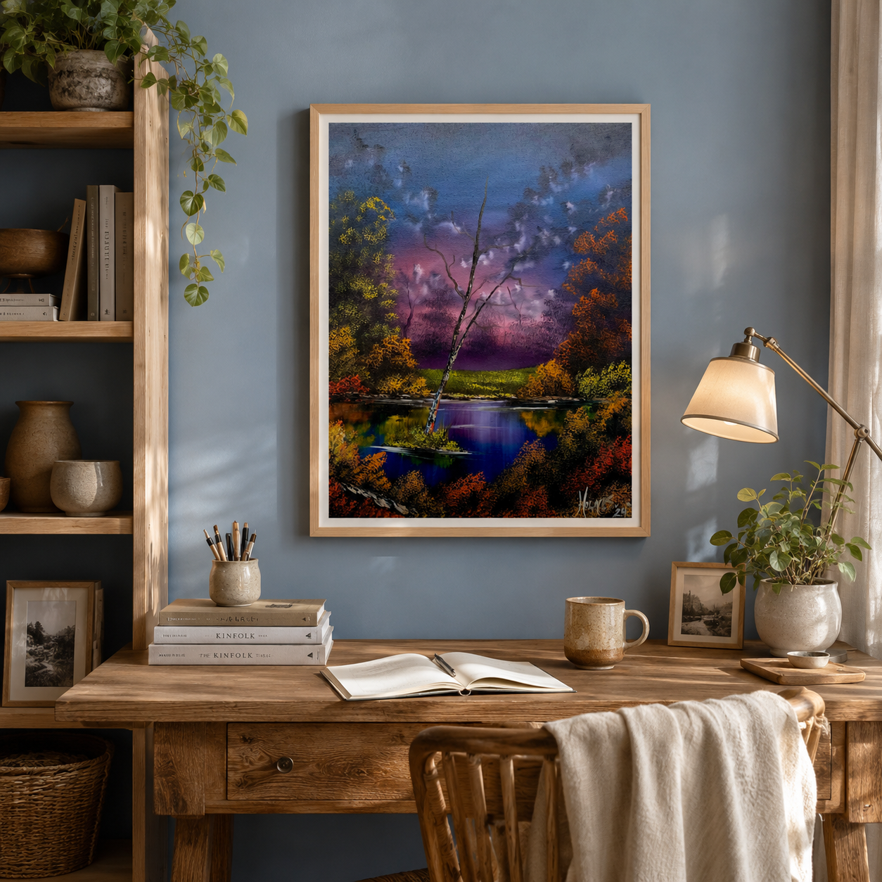 purple and blue artwork on fine art print of a dusky pond scene. Vibrant colors of the artwork stand out against delicate blue wall and wooden writing desk