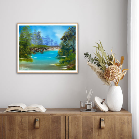 Framed landscape painting on a wall above a wooden cabinet with decorative items.