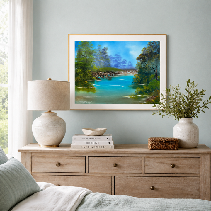fine art print of a Tennessee river view in a gold frame over the dresser displayed in the bedroom