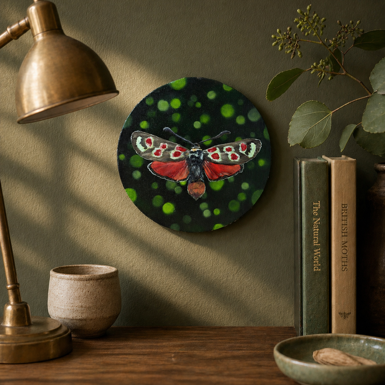 Lucy red white and brown moth 8" original oil painting on round canvas over console table with books and a lamp