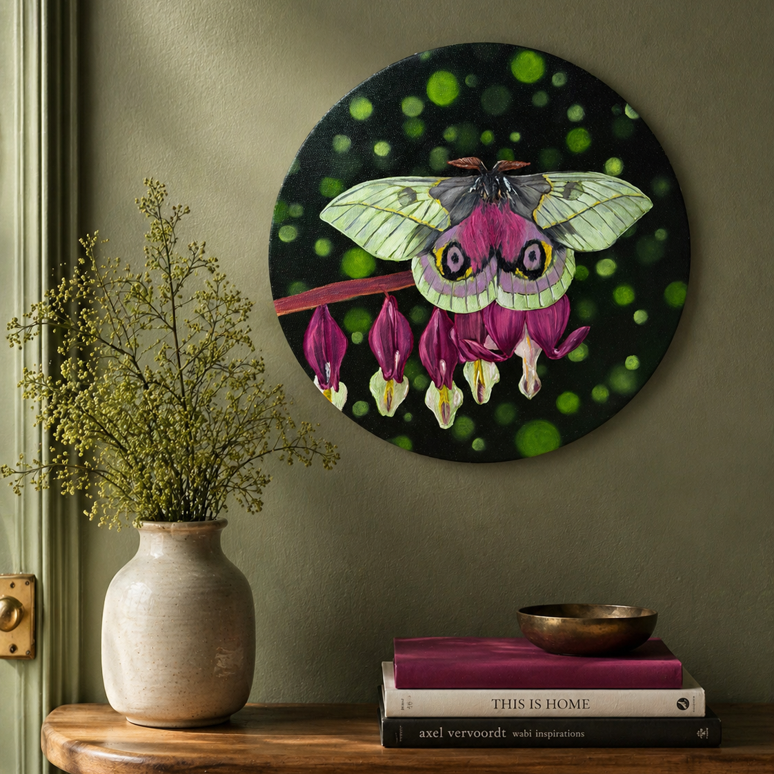 Original oil painting of a white and pink moth sitting on pink bleeding hearts flowers on a 12" round canvas - displayed on sage wall