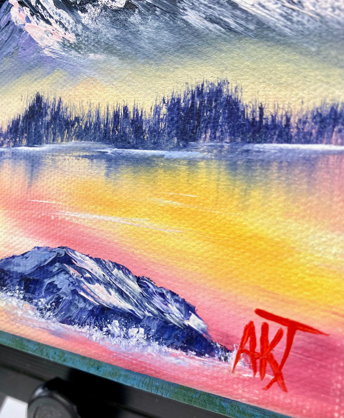 Colorful oil painting with a mountain, trees, and a signature in red.