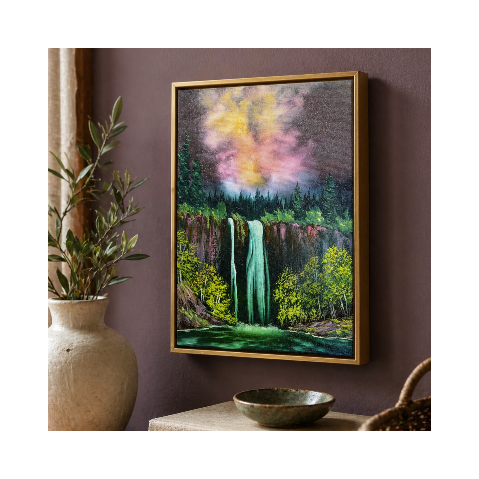Framed painting of a forest with a waterfall on a purple wall, next to a plant and a bowl.