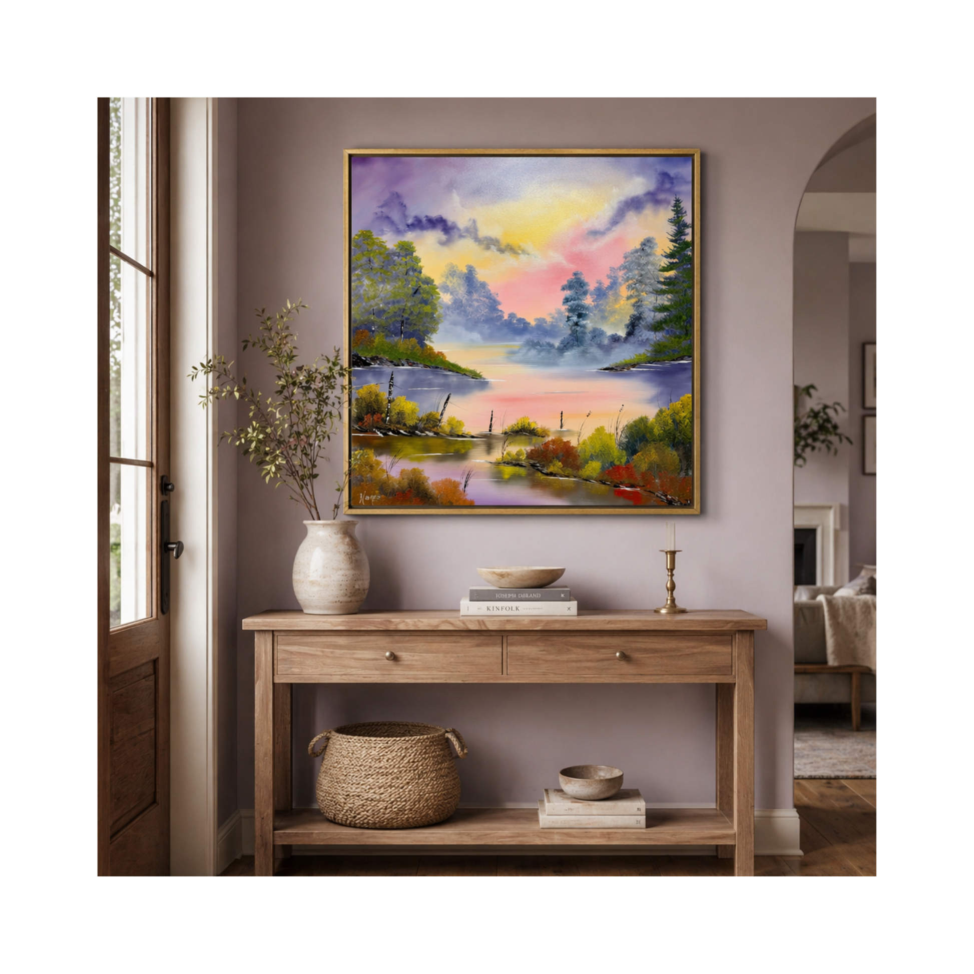 Framed colorful landscape painting of the Tennessee river above a wooden console table in a room.