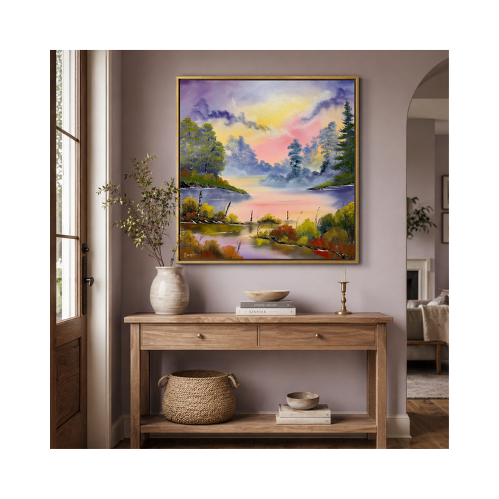 Framed colorful landscape painting of the Tennessee river above a wooden console table in a room.