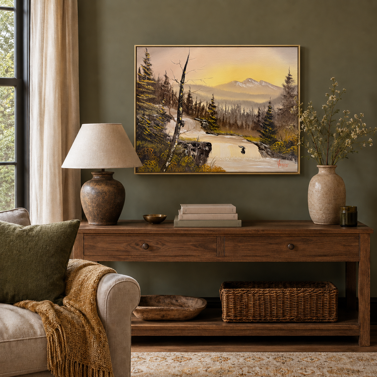 Living room with a wooden console table, lamp, and painting of a warm golden mountain landscape.