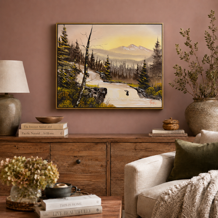 Living room with a painting of a mountain landscape on the wall, a wooden cabinet, and a beige armchair.