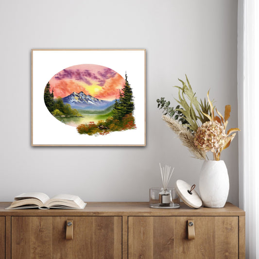 Framed artwork of a mountain landscape on a wall above a wooden cabinet with decor items.