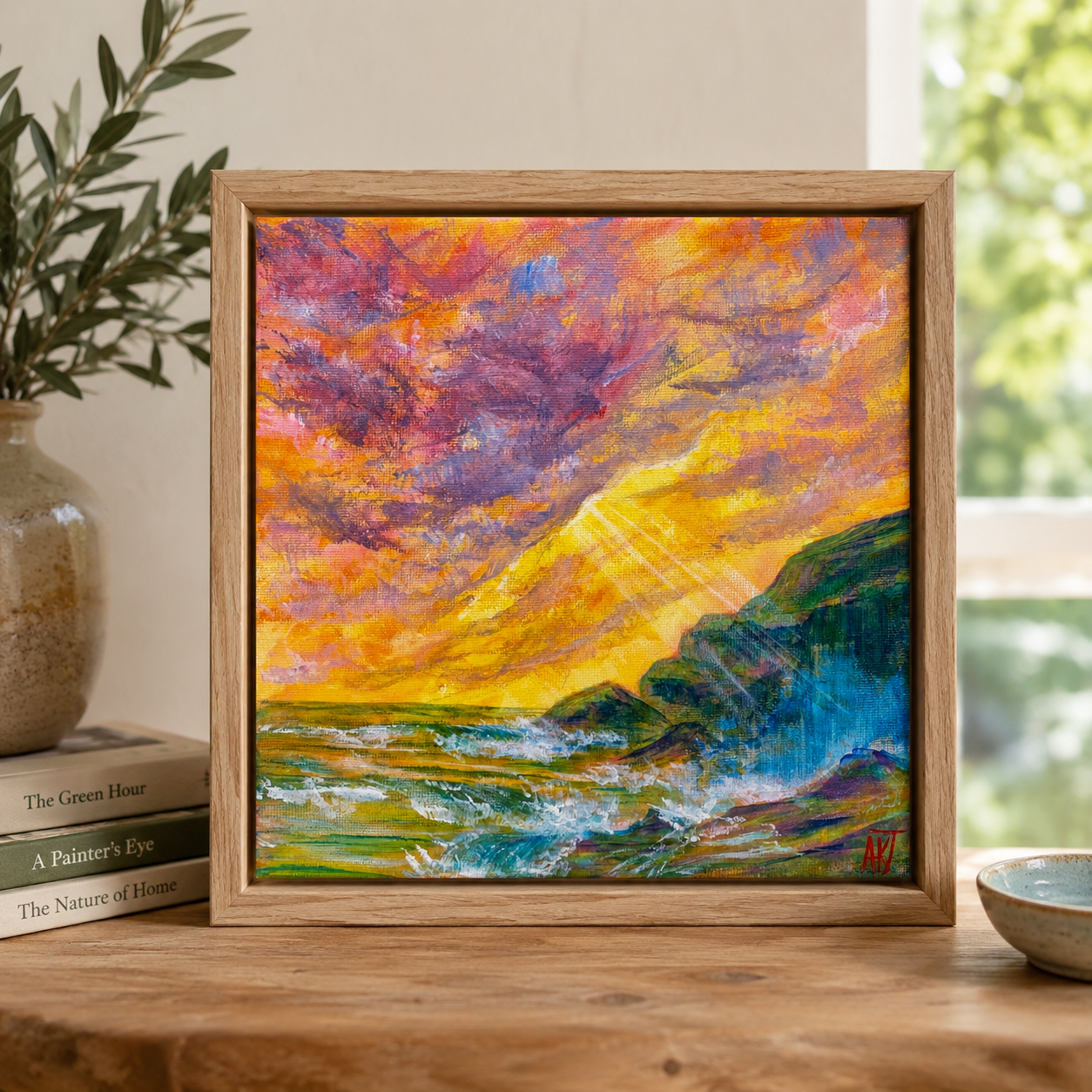 8x8" square brightly colored acrylic artwork on canvas of a seascape with a light bursting through the clouds displayed on a shelf