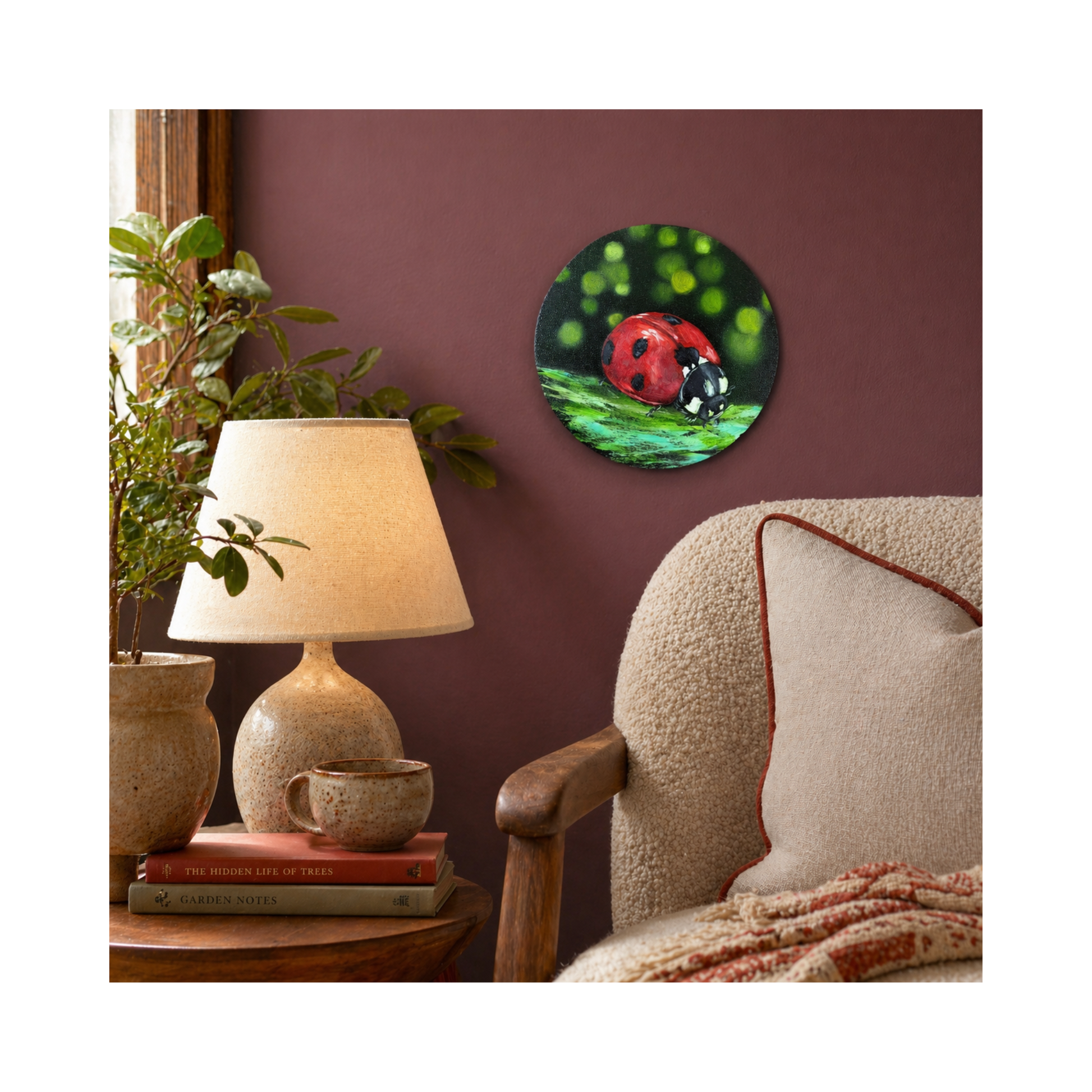ladybird original oil painting on 8" round canvas displayed on the mauve wall over the cozy armchair