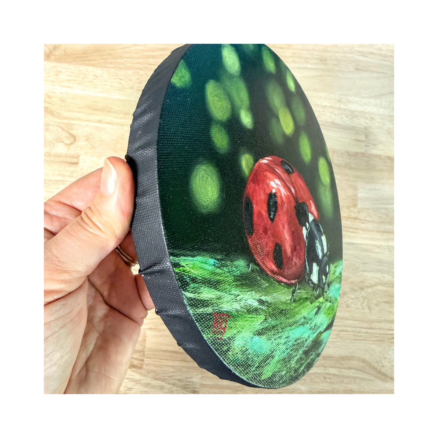 ladybird original oil painting on 8" round canvas side view showing the black edge