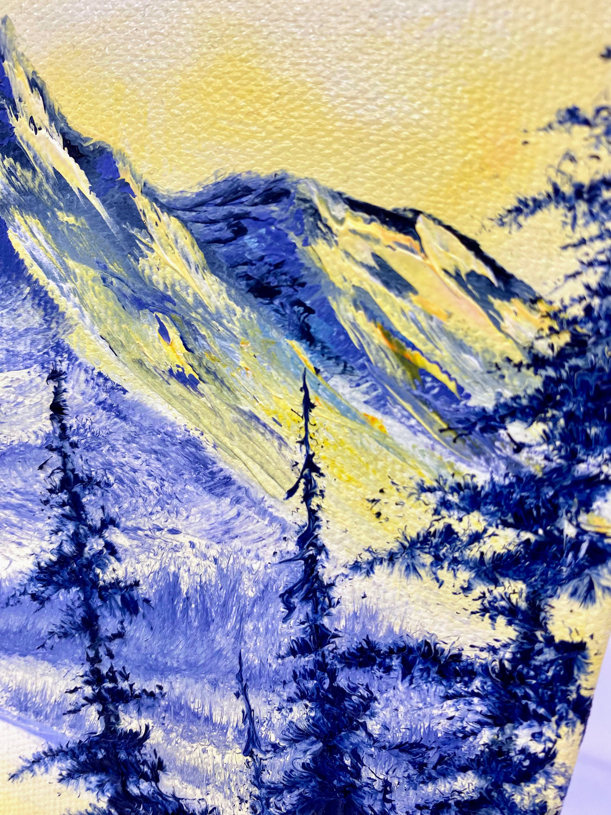 Painting of a mountain landscape with trees in blue and yellow tones